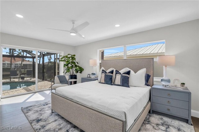 bedroom with light wood-type flooring, access to outside, and multiple windows