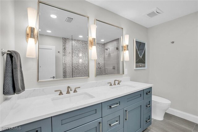 bathroom featuring vanity, toilet, and walk in shower