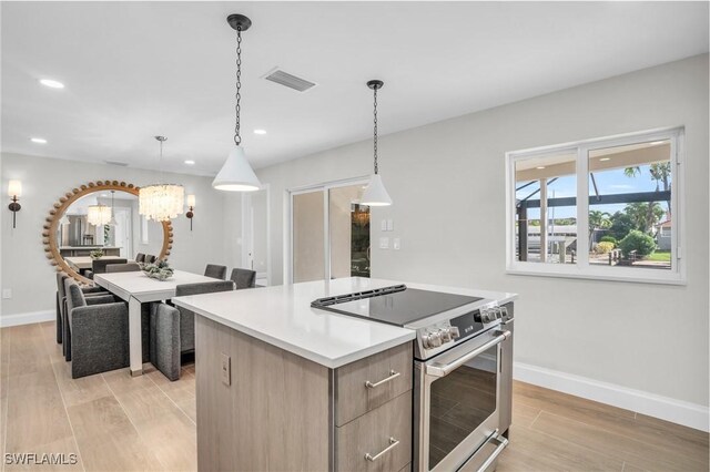 kitchen with light hardwood / wood-style flooring, a center island, hanging light fixtures, and stainless steel electric range