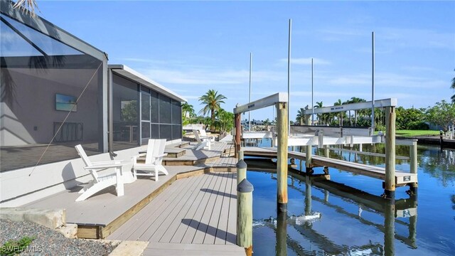 dock area with glass enclosure and a water view