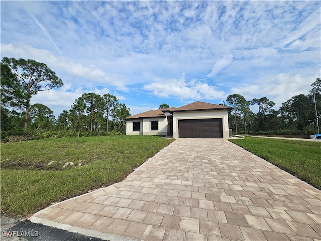 view of front of property featuring a garage and a front yard