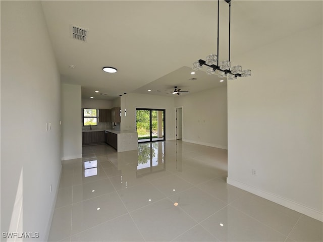 unfurnished living room with ceiling fan and light tile patterned flooring