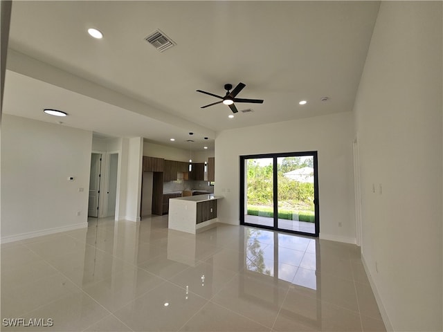 unfurnished living room with light tile patterned floors and ceiling fan