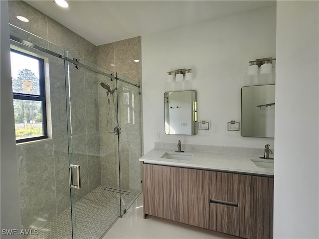 bathroom featuring vanity, tile patterned floors, and a shower with door