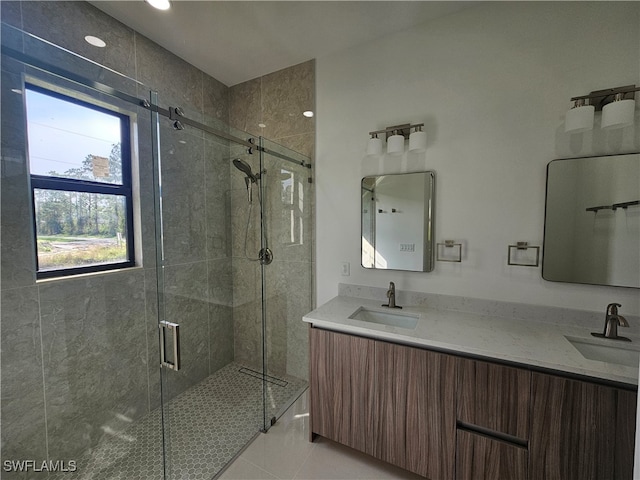 bathroom with tile patterned flooring, vanity, and an enclosed shower