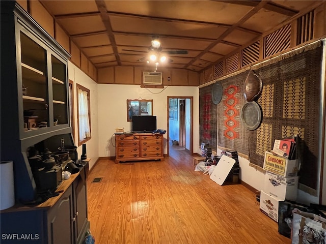 miscellaneous room featuring a wall mounted AC, ceiling fan, hardwood / wood-style floors, and lofted ceiling