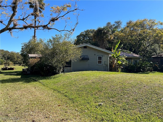 1603 Tom Coker Rd, Labelle, FL 33935 - view of side of home featuring a lawn