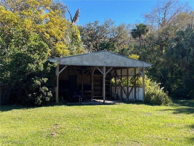 1603 Tom Coker Rd, Labelle, FL 33935 - view of grassy yard featuring an outbuilding and a detached carport