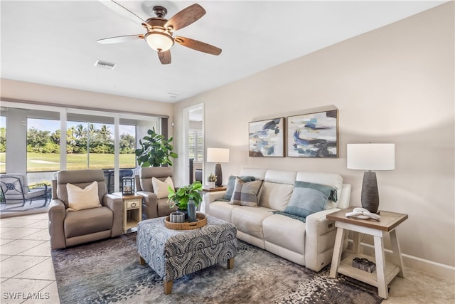 tiled living room with ceiling fan