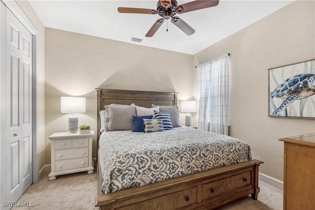 carpeted bedroom featuring ceiling fan and a closet