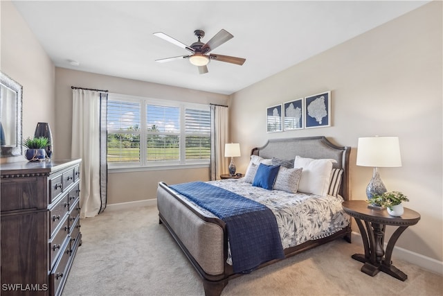 bedroom with ceiling fan and light colored carpet