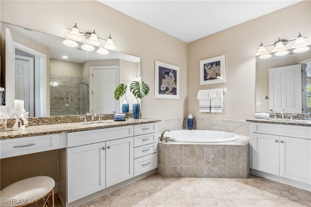 bathroom featuring tile patterned flooring, vanity, and shower with separate bathtub