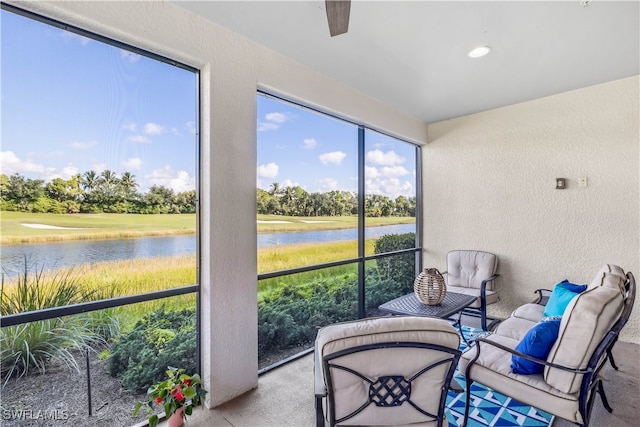 sunroom / solarium featuring a water view