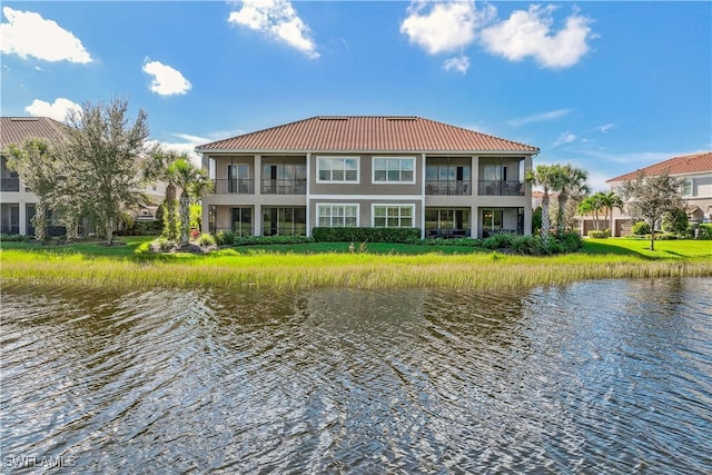 back of house with a water view