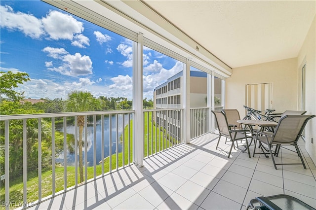 unfurnished sunroom featuring a water view