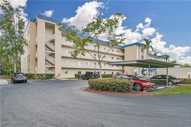 view of property with covered and uncovered parking