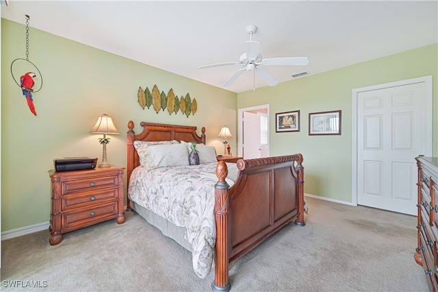 bedroom with ceiling fan and light carpet