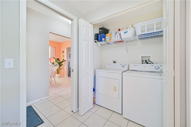 washroom with washer and dryer and light tile patterned floors