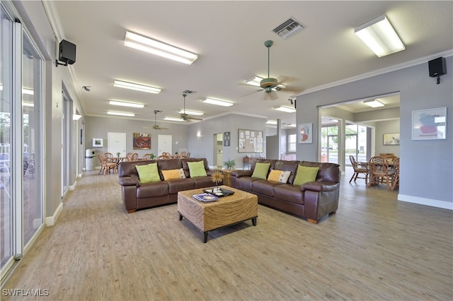 living room with ornamental molding, light hardwood / wood-style flooring, and ceiling fan