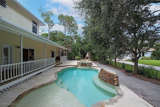 view of swimming pool featuring an in ground hot tub and a patio