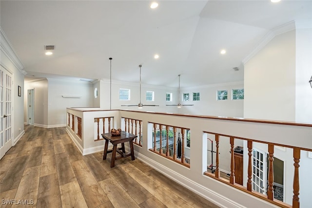 hall featuring ornamental molding, lofted ceiling, and wood-type flooring