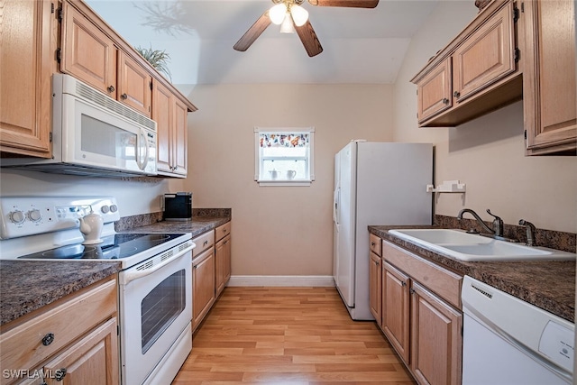 kitchen with vaulted ceiling, white appliances, light hardwood / wood-style flooring, sink, and ceiling fan