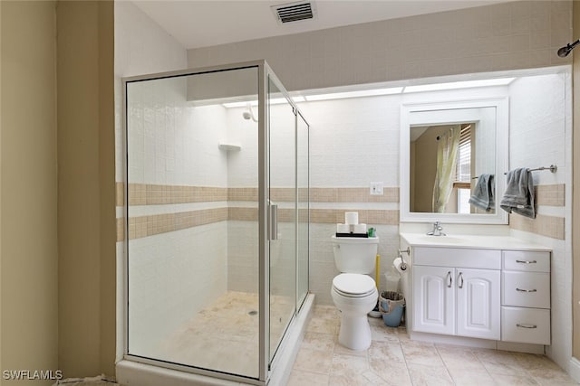 bathroom with vanity, toilet, walk in shower, and tile patterned floors