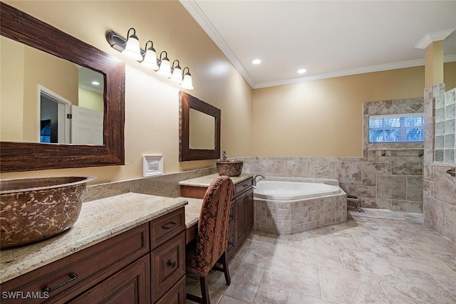 bathroom with crown molding, vanity, and tiled bath