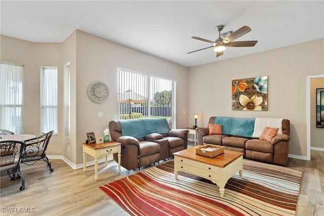 living room featuring ceiling fan and light hardwood / wood-style flooring