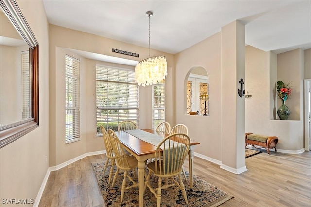 dining area featuring a notable chandelier and light hardwood / wood-style flooring