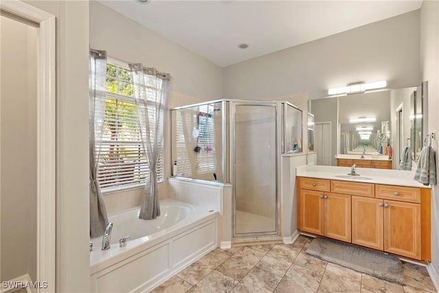 bathroom featuring vanity and shower with separate bathtub