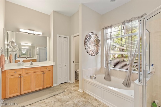 full bathroom with toilet, separate shower and tub, and vanity