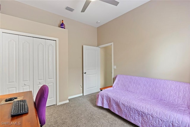 carpeted bedroom with ceiling fan and a closet