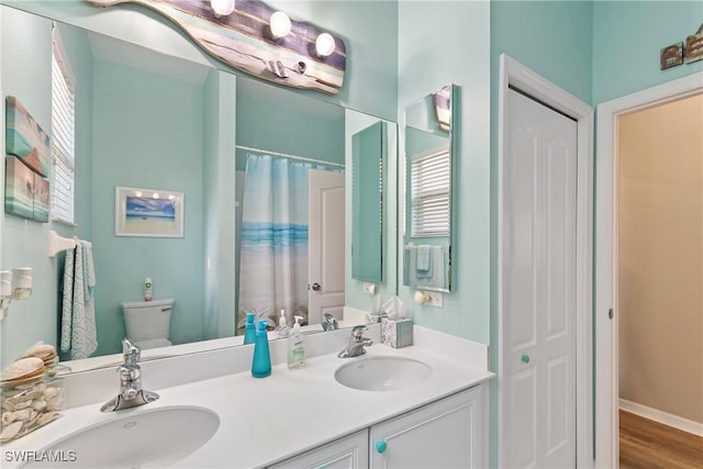 bathroom featuring toilet, a shower with shower curtain, vanity, and hardwood / wood-style floors