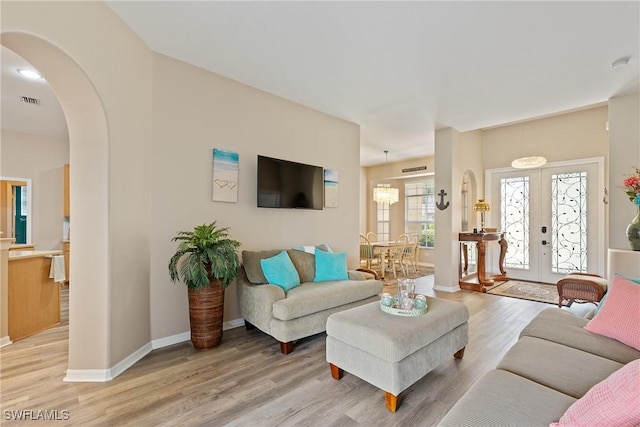 living room featuring light hardwood / wood-style floors and french doors