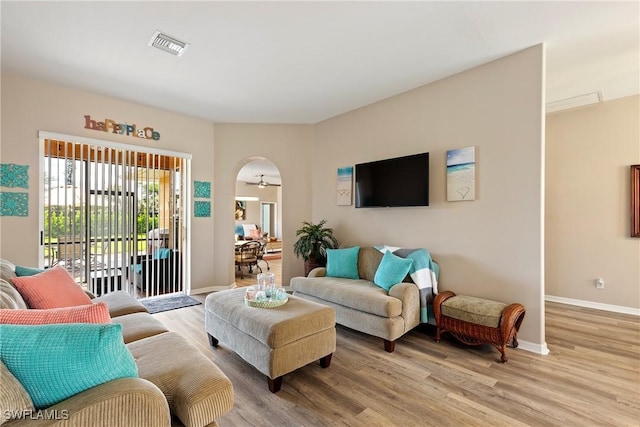 living room featuring ceiling fan and light wood-type flooring