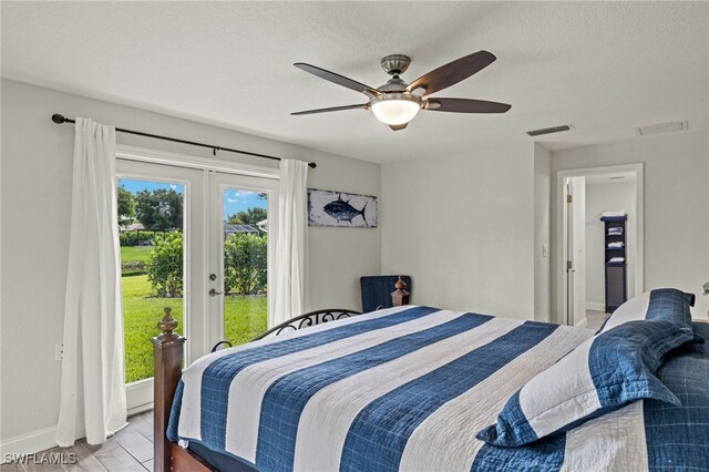 bedroom with french doors, access to exterior, ceiling fan, a textured ceiling, and light hardwood / wood-style flooring