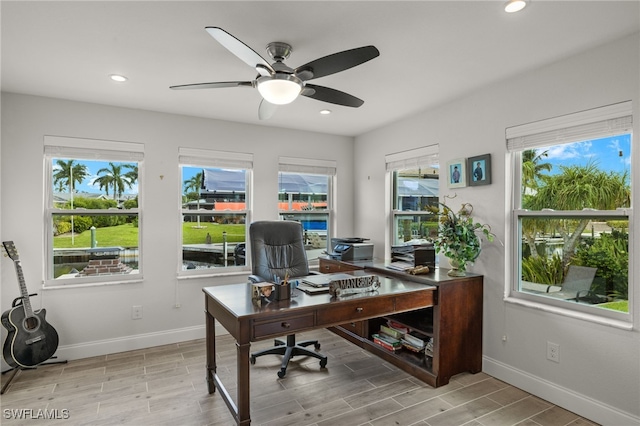 office space with baseboards, recessed lighting, light wood-type flooring, and ceiling fan