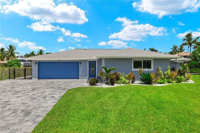 ranch-style house featuring decorative driveway, stucco siding, fence, a garage, and a front lawn