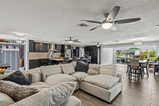 living room featuring dark wood-type flooring and a textured ceiling