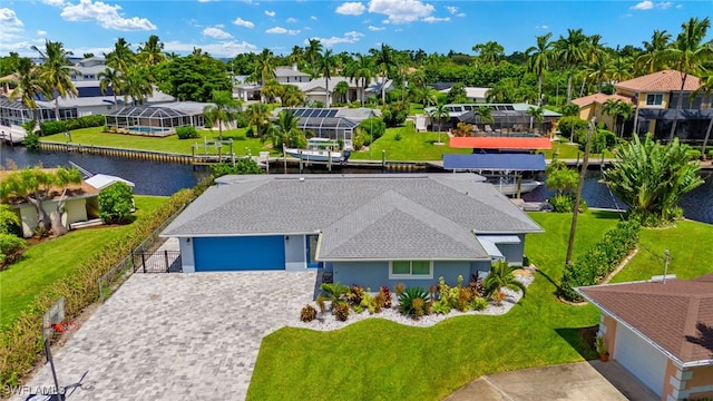 drone / aerial view featuring a water view and a residential view