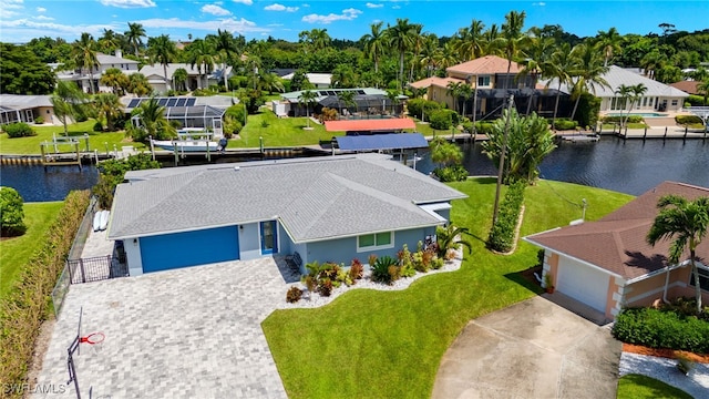 birds eye view of property featuring a water view and a residential view