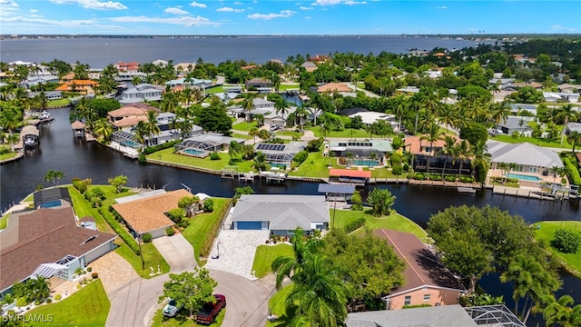 drone / aerial view with a water view and a residential view