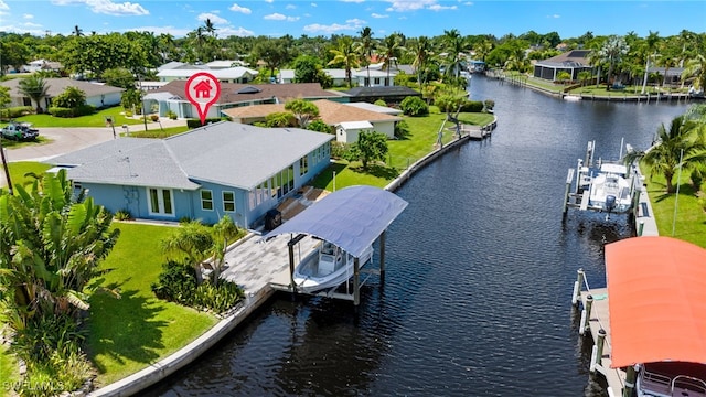 drone / aerial view featuring a water view and a residential view