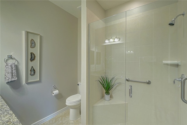 bathroom with toilet, tile patterned floors, and a shower with door