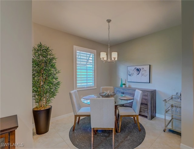 dining area featuring a chandelier and light tile patterned flooring