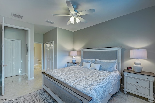 bedroom featuring a closet, ceiling fan, and light tile patterned flooring