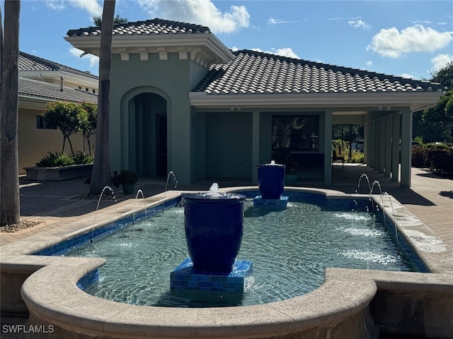 view of swimming pool with a patio area and pool water feature