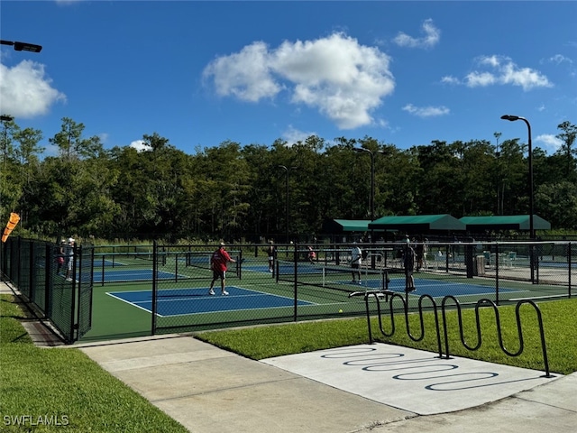 view of sport court featuring a yard