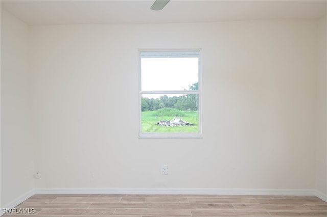 spare room with light wood-type flooring and ceiling fan